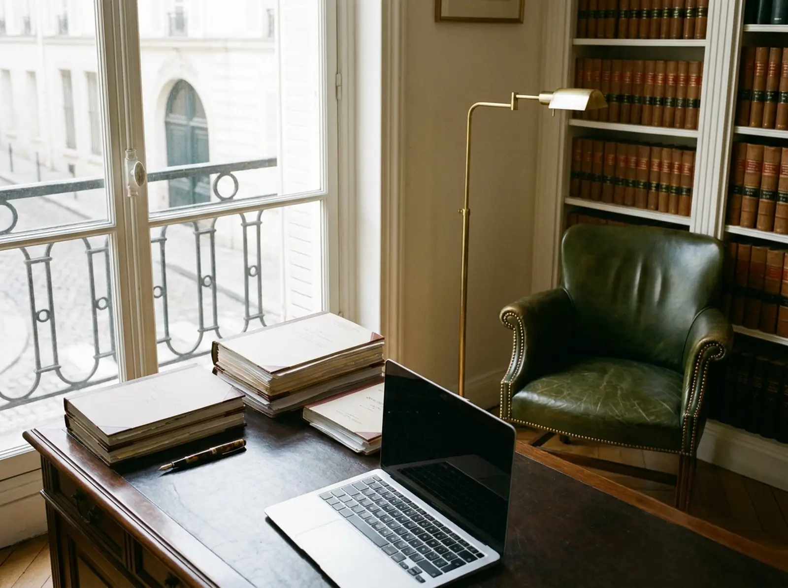 Parisian law office with case files, a fountain pen and a legal library
